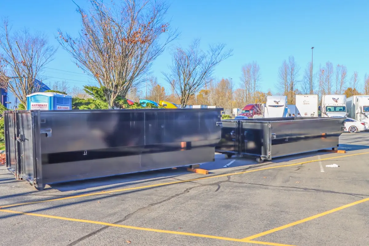 Professional dumpster rental service with roll-off container on residential driveway in Carolina Shores